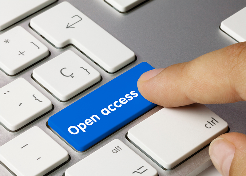 A finger pressing a blue "open access" button on a computer keyboard