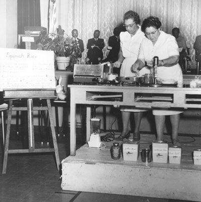 A recipe being created in an old photograph for the Pickles to Pudding exhibit.