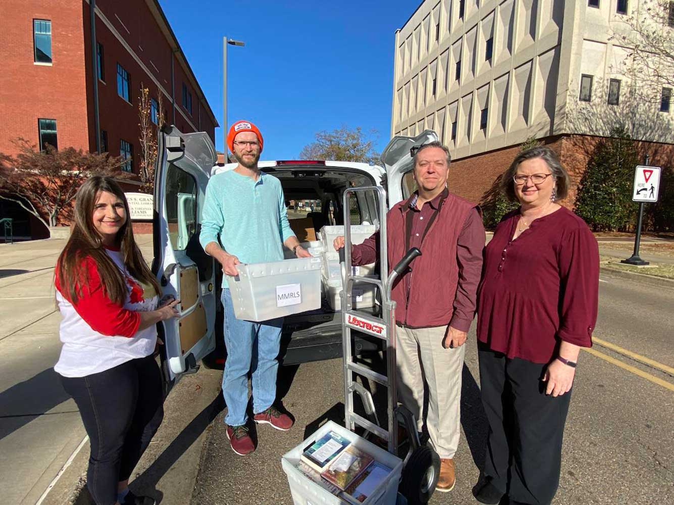 Members of the MSU Libraries load the van with materials for the Mississippi Library Partnership.