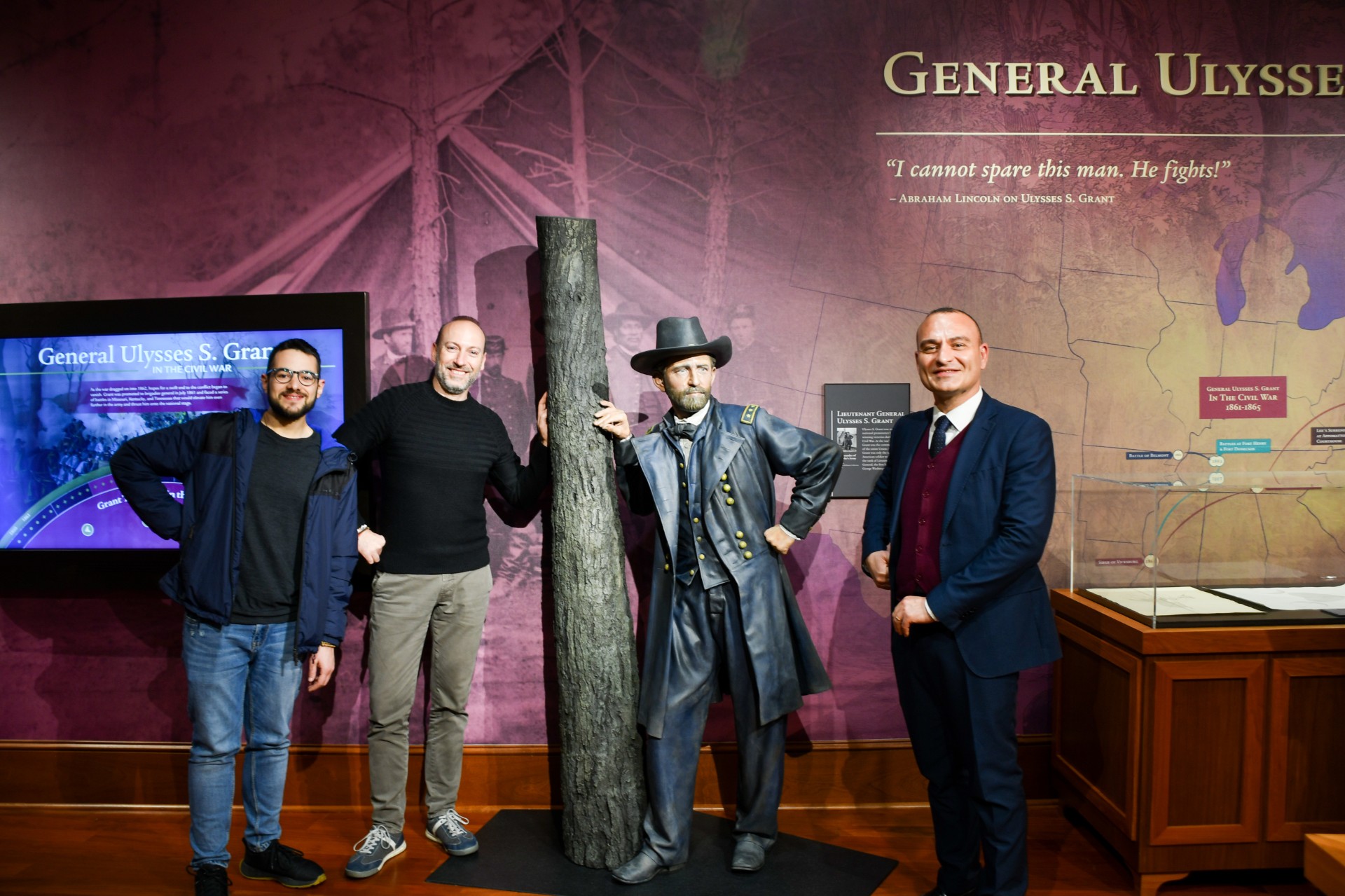 Four guests pose beside a lifelike statue of Ulysses S. Grant at an exhibit in Mississippi State University Libraries.