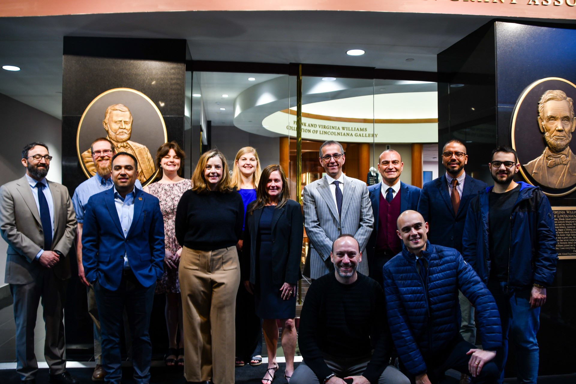 Mississippi State University Libraries faculty, staff, and international guests from the Pontifical University Antonianum, including Anne Marshall and Dean Keith, pose together in front of Ulysses S. Grant and Abraham Lincoln displays.