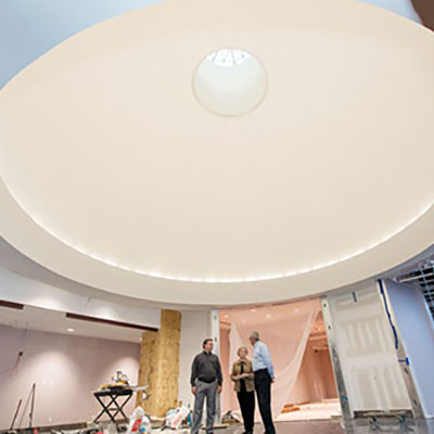 Group of three standing under a rotunda.