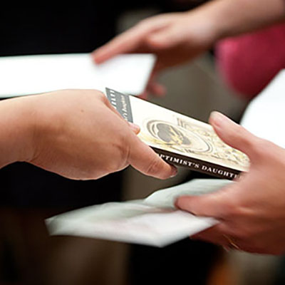 Hands exchanging books.