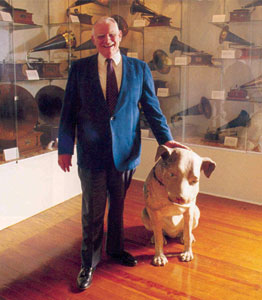 Charles H. Templeton, Sr. and Nipper with gramophone collection behind them.