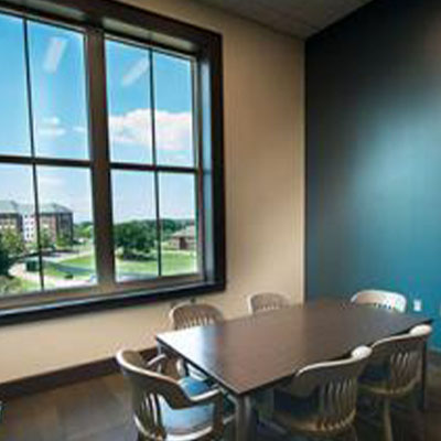 Study room work table in front of large picture windows.
