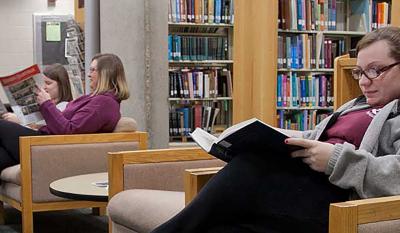 Several students in the reading room of the College of Veterinary Medicine Library.