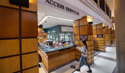 A patron approaches the Access and Information desk.