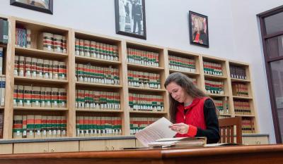 A researcher at a work table looking at documents.