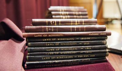 A stack of leather bound law books.