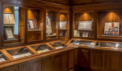 Items from the John Grisham collection displayed in glass cases.